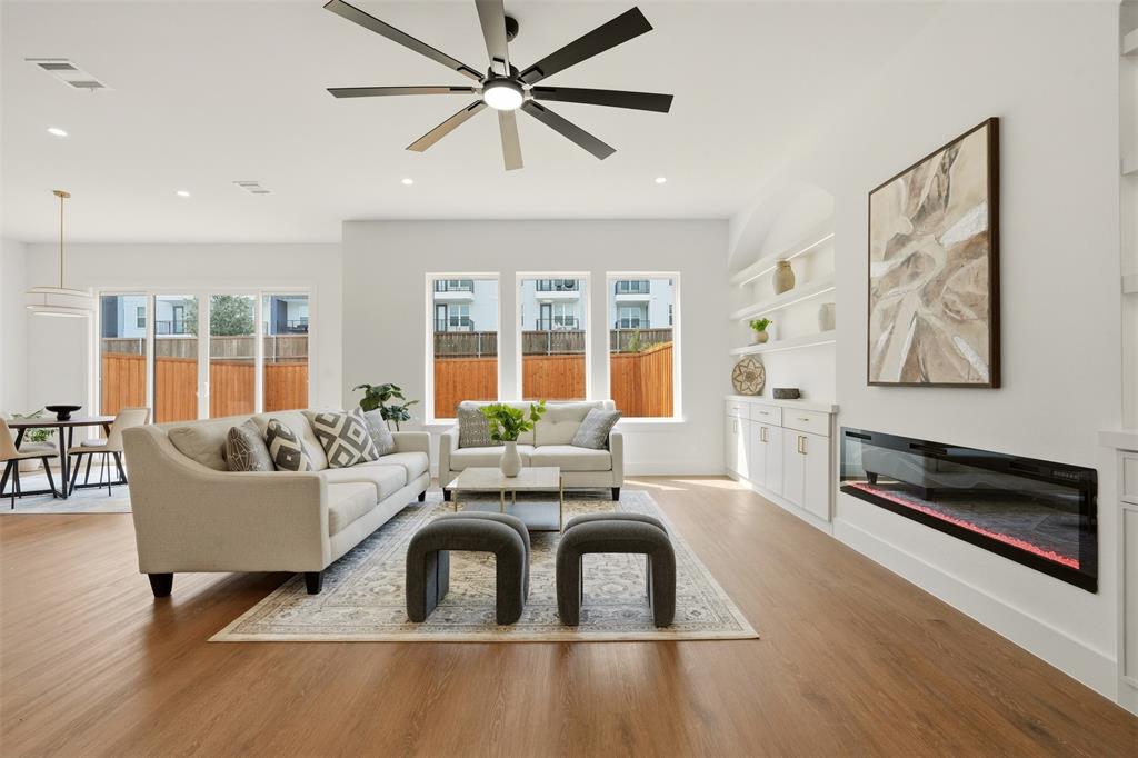 Wood-finish flooring, recessed lighting, and a modern ceiling fan Wood-finish flooring, recessed lighting, and a modern ceiling fan