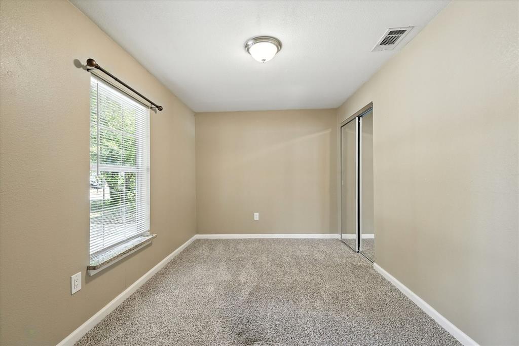 Secondary bedroom with view out the front of the  home