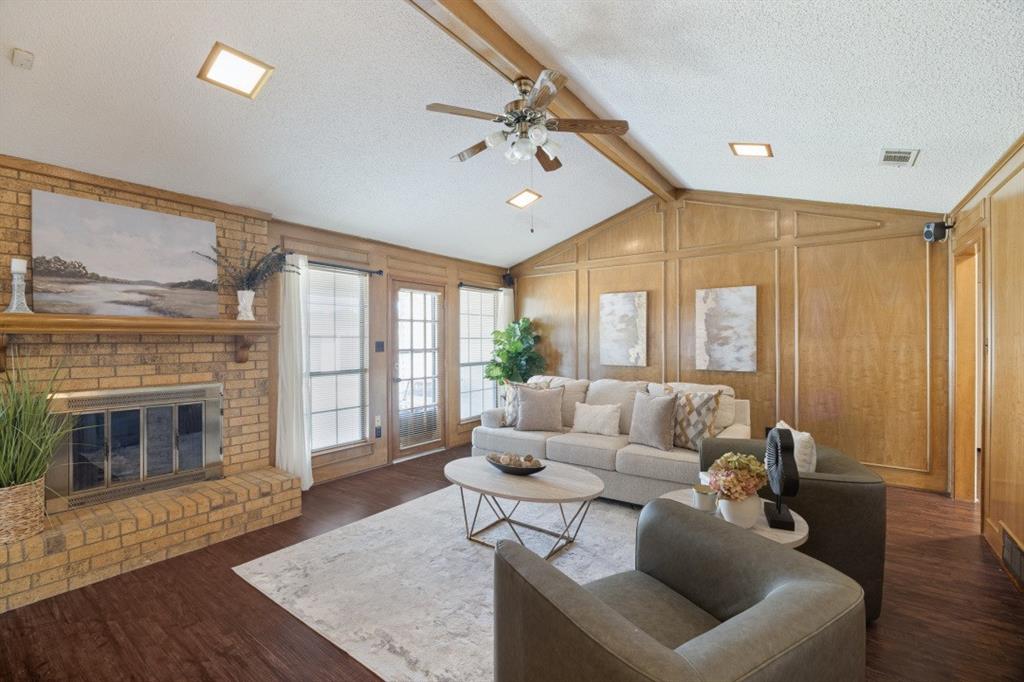 Cozy gas fireplace with gas logs and a patio door leading to the backyard.