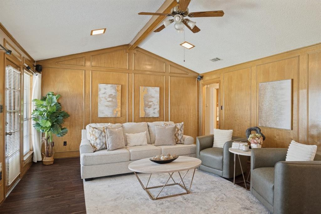 The living room is warm and inviting with beautiful paneling and beamed ceiling.