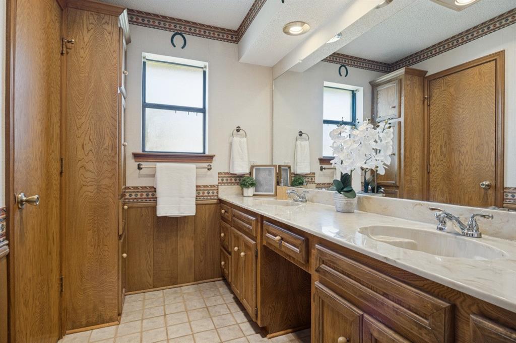 Primary bathroom features two sinks and a shower.