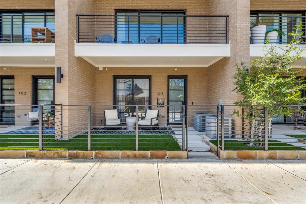 Brick facade with private patio featuring artificial turf