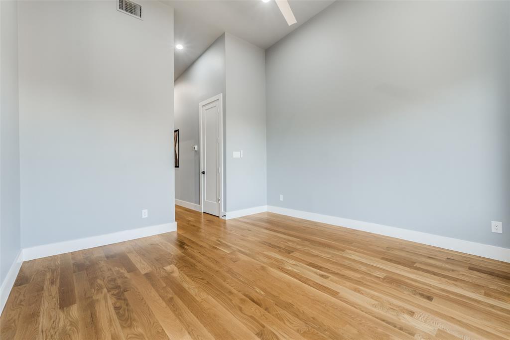 Hardwood flooring, painted walls, vaulted ceiling, recessed lighting, and a ceiling fan