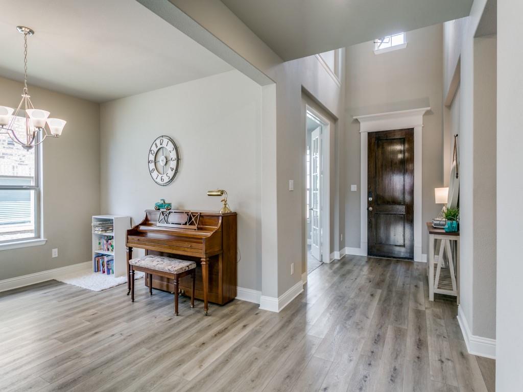 Welcoming foyer featuring soaring ceilings and luxury vinyl plank flooring