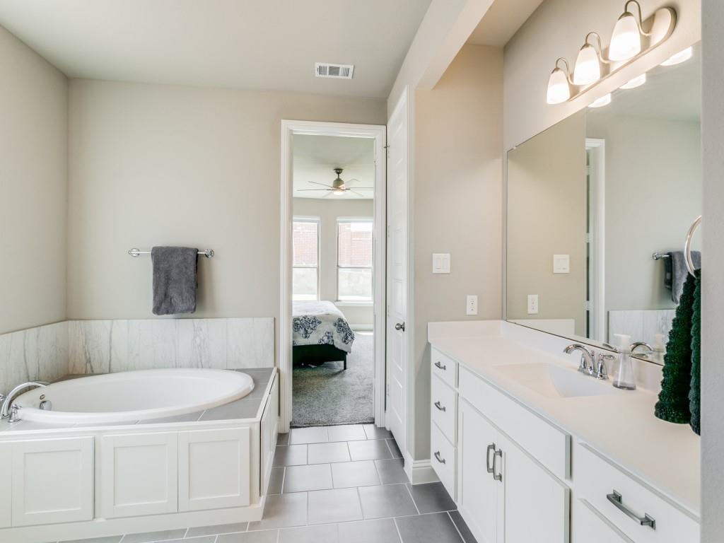 Primary bath features separate vanities recently upgraded to granite and soaking tub