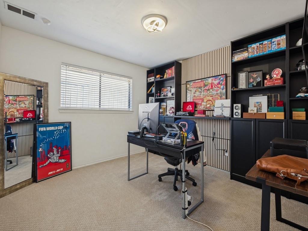 Built-in black cabinetry with open shelving, vertical slat wall paneling, and a contemporary flush-mount ceiling light fixture