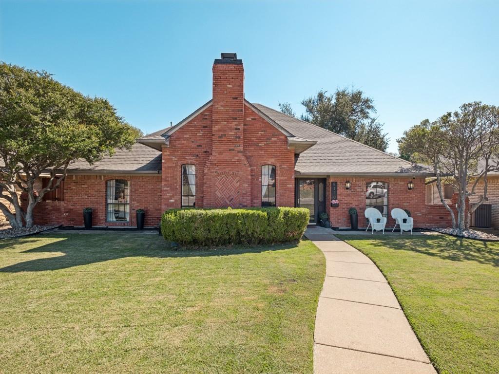 Traditional brick exterior featuring an arched brick chimney, intricate masonry detail, arched windows, and a paved walkway Traditional brick exterior featuring an arched brick chimney, intricate masonry detail, arched windows, and a paved walkway