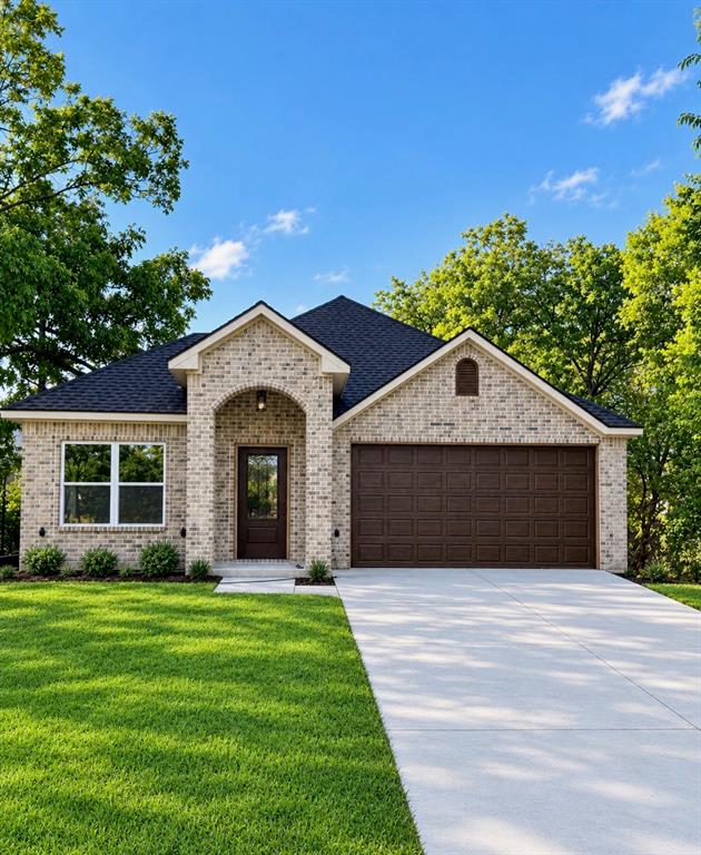 Exterior facade featuring light-toned brick masonry, an arched entryway, a dark shingled roof, a double-car garage, and a concrete driveway