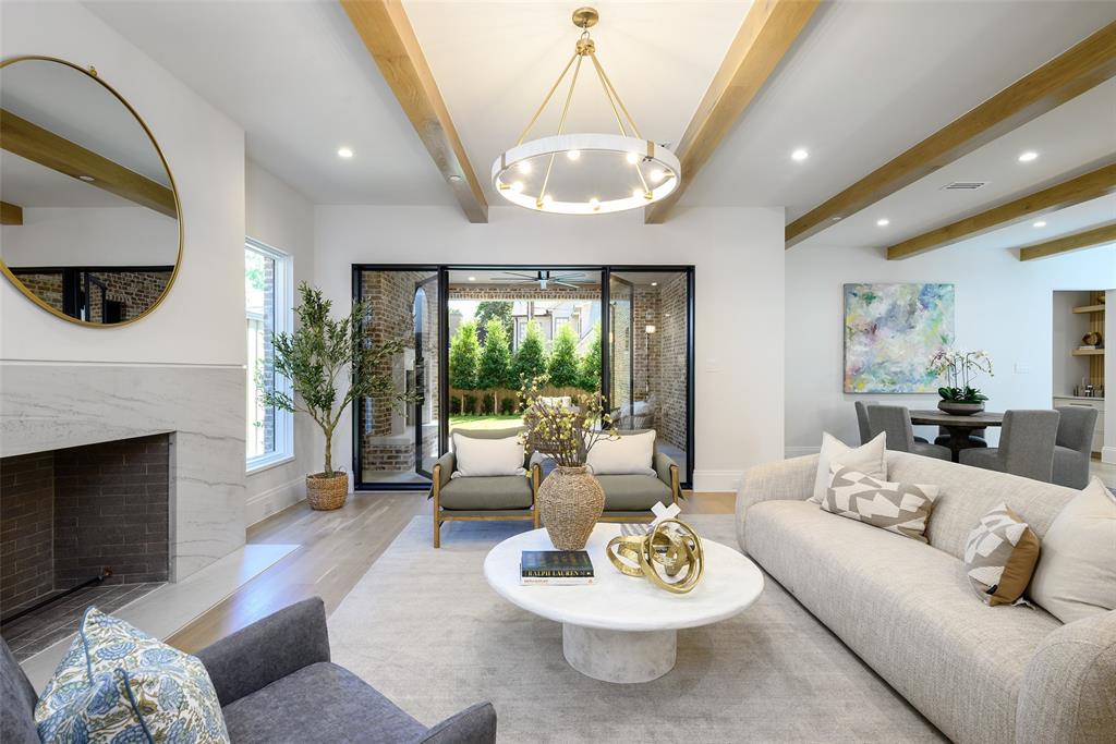 Large, open family living room with Isokern Magnum wood-burning fireplace with leathered natural stone slab surround and hearth