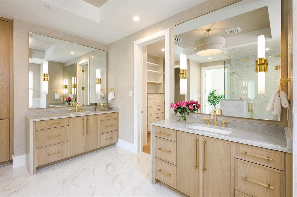 Primary bath with Venetian plaster walls, waterfall-style stone countertops and white oak soft-close cabinetry, free standing tub, walk-in shower and walk-in custom closet