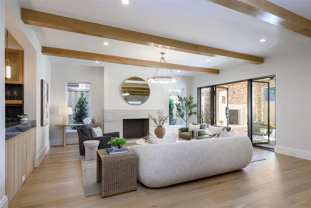 Large, open family living room with Isokern Magnum wood-burning fireplace with leathered natural stone slab surround and hearth