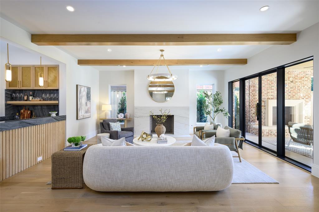Large, open family living room with Isokern Magnum wood-burning fireplace with leathered natural stone slab surround and hearth