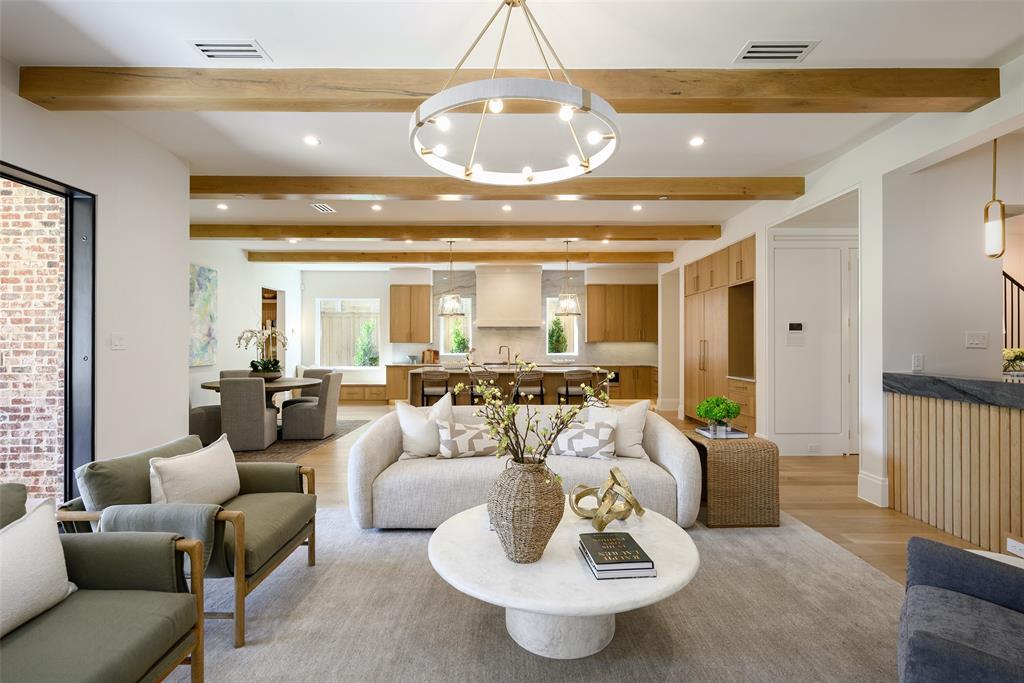 Large, open family living room with Isokern Magnum wood-burning fireplace with leathered natural stone slab surround and hearth