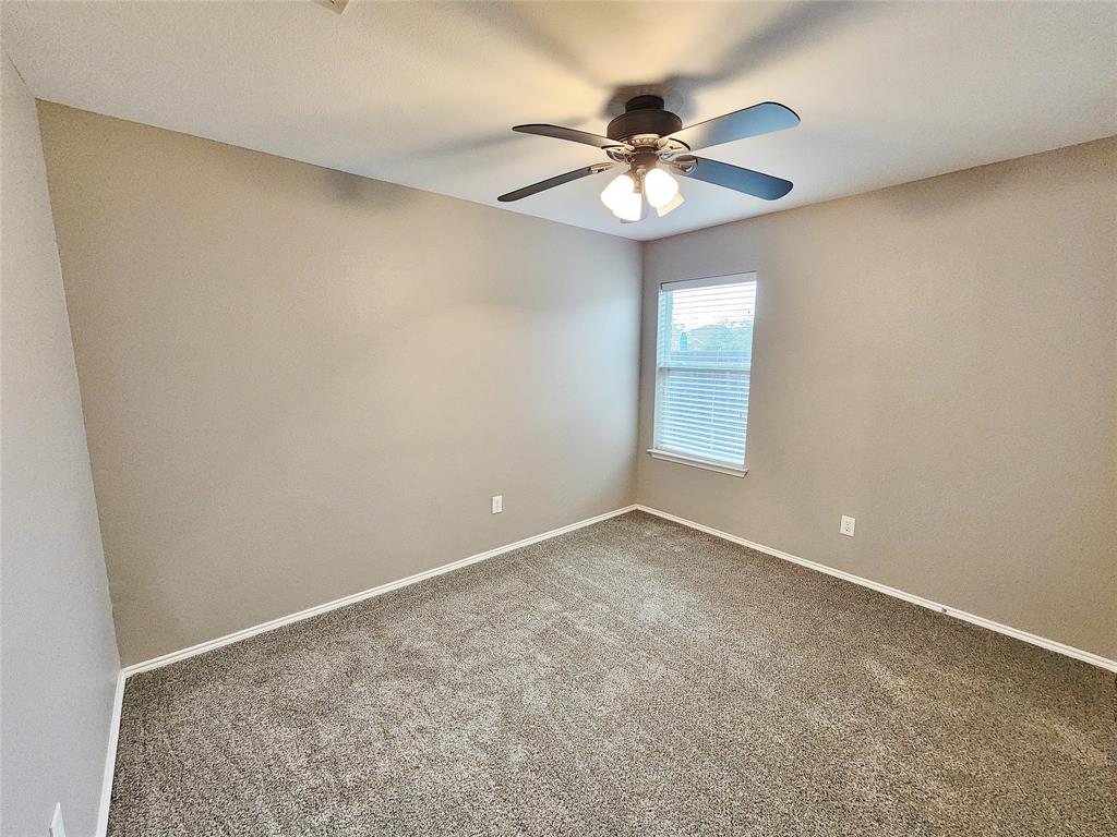 Neutral-toned walls complement the textured carpet flooring