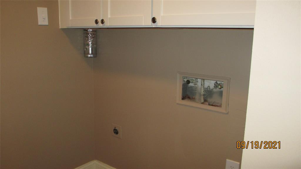 Washer and dryer area with built in cabinets Washer and dryer area with built in cabinets