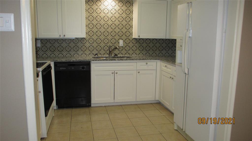 Kitchen with Maytag refrigerator designer backsplash