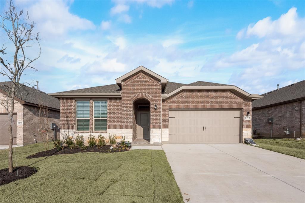 View of front of house with a garage and a front lawn View of front of house with a garage and a front lawn