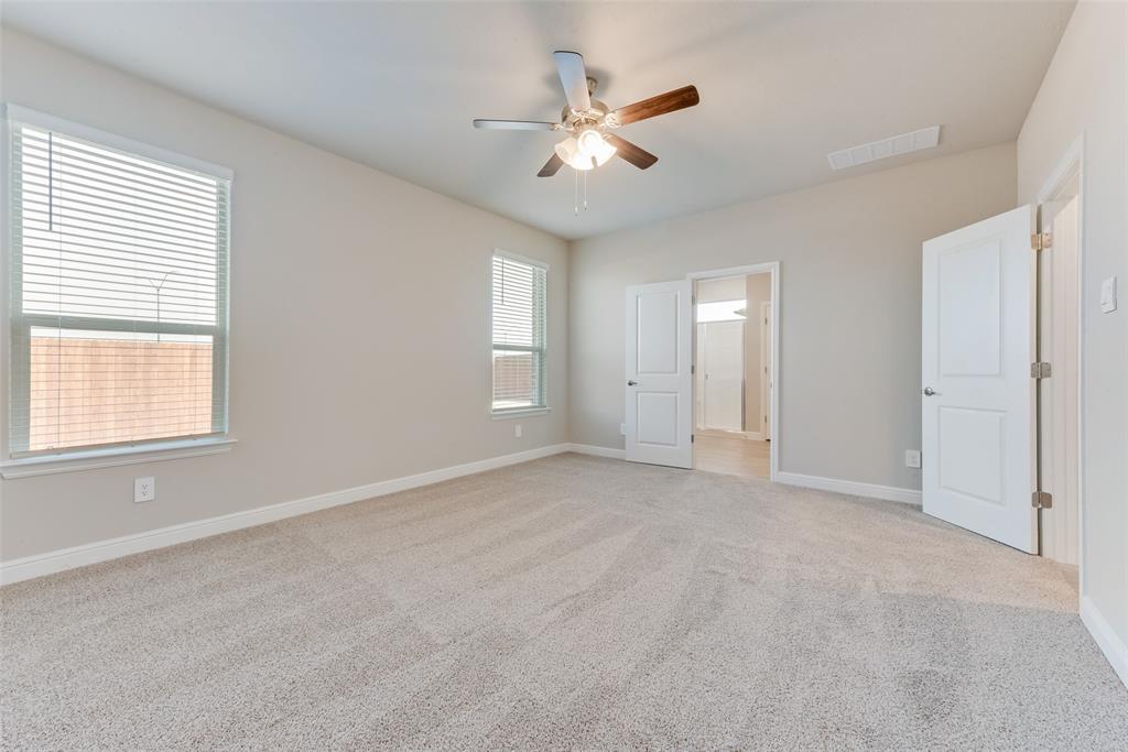 Unfurnished bedroom featuring light colored carpet and ceiling fan