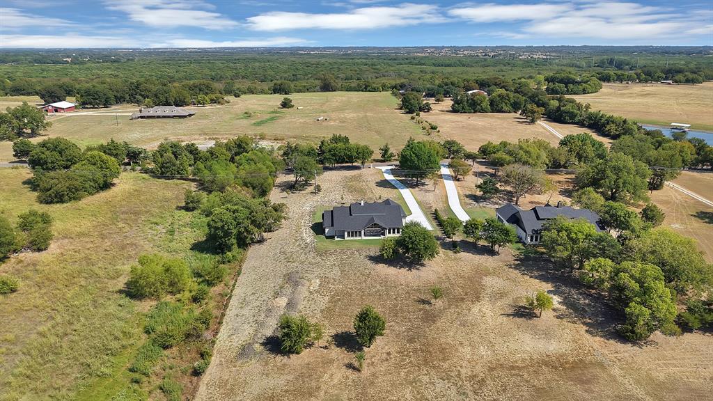 Expansive rural setting with mature trees,