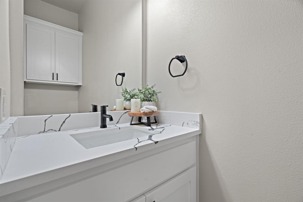 half bath located near garage entrance by utility room