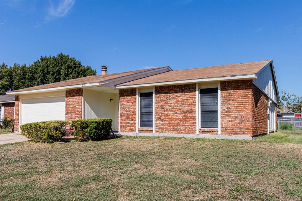 Single-story residence featuring a brick facade, low-pitched roof, attached two-car garage, and established landscaping Single-story residence featuring a brick facade, low-pitched roof, attached two-car garage, and established landscaping