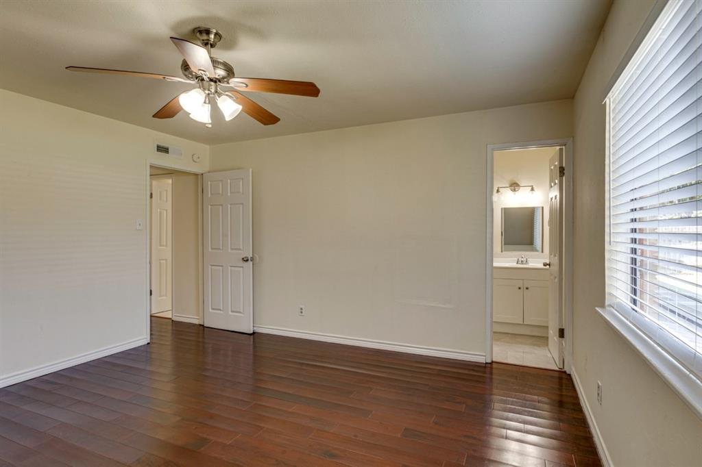 Room featuring wood-finish flooring, ceiling fan with integrated lighting, dual-panel interior doors, and horizontal window blinds