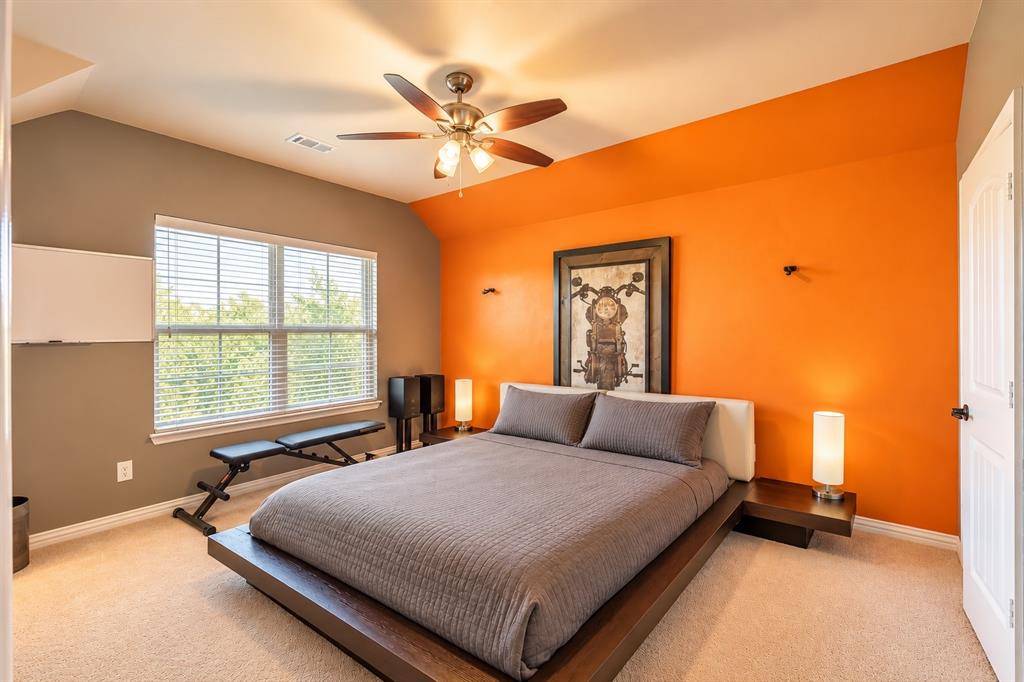 Carpeted room featuring a ceiling fan, window with horizontal blinds, and a paneled door