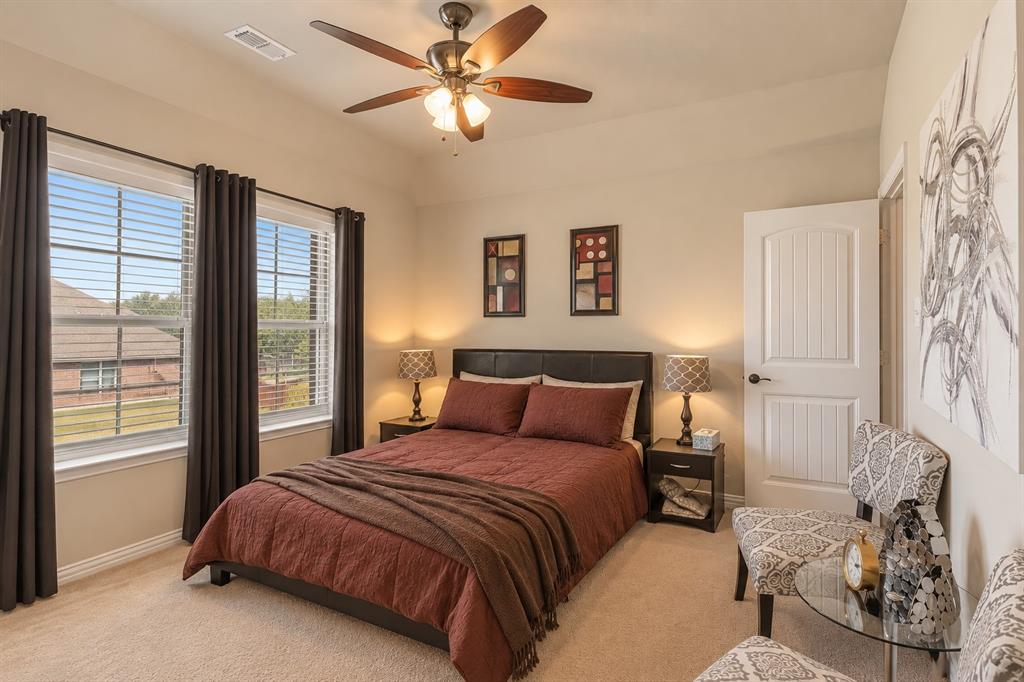 Recessed lighting, ceiling fan with integrated light fixture, dual windows with blinds and curtain rods, paneled interior door, and carpeted flooring