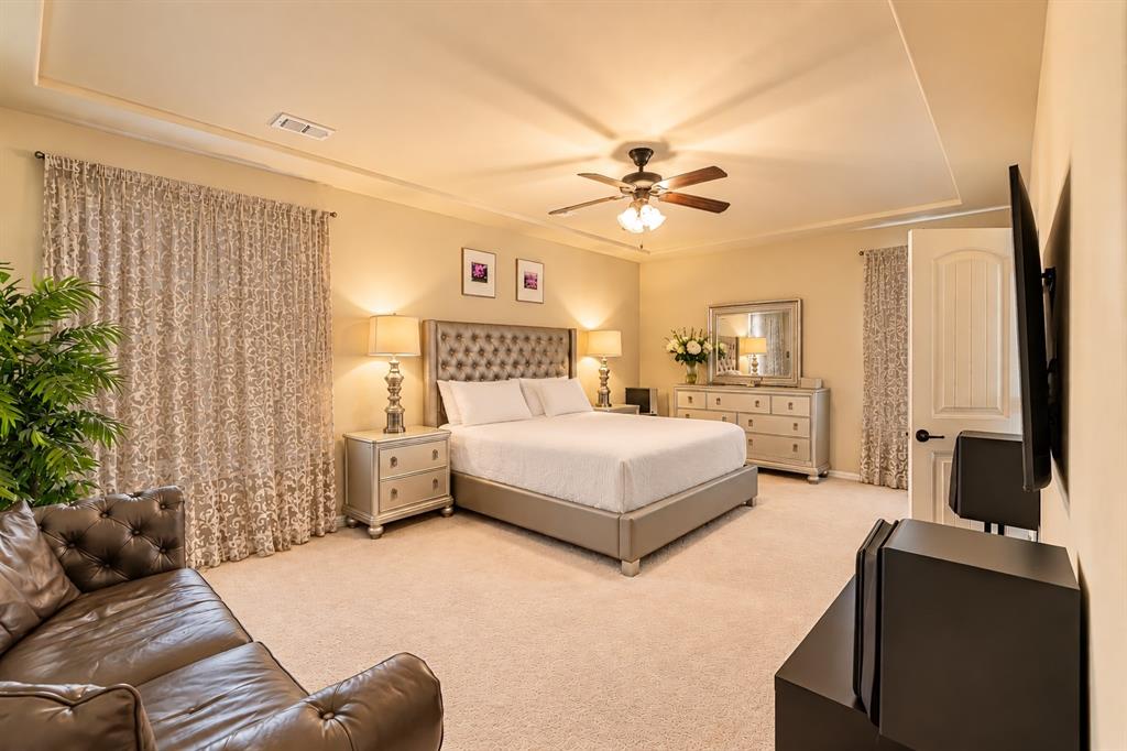 Recessed ceiling with an integrated ceiling fan, light-toned walls, and soft carpet flooring