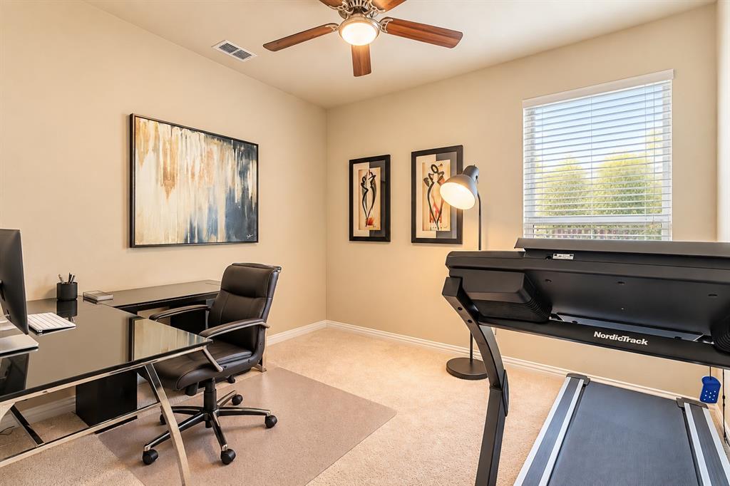 Recessed ceiling light with a wood-finish ceiling fan, neutral wall paint, and carpet flooring