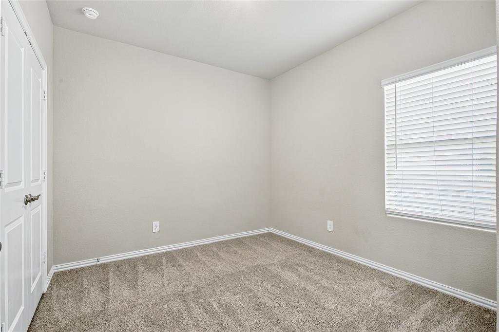 Recessed ceiling light fixture, neutral wall paint, carpeted flooring, white trim, and a window with blinds