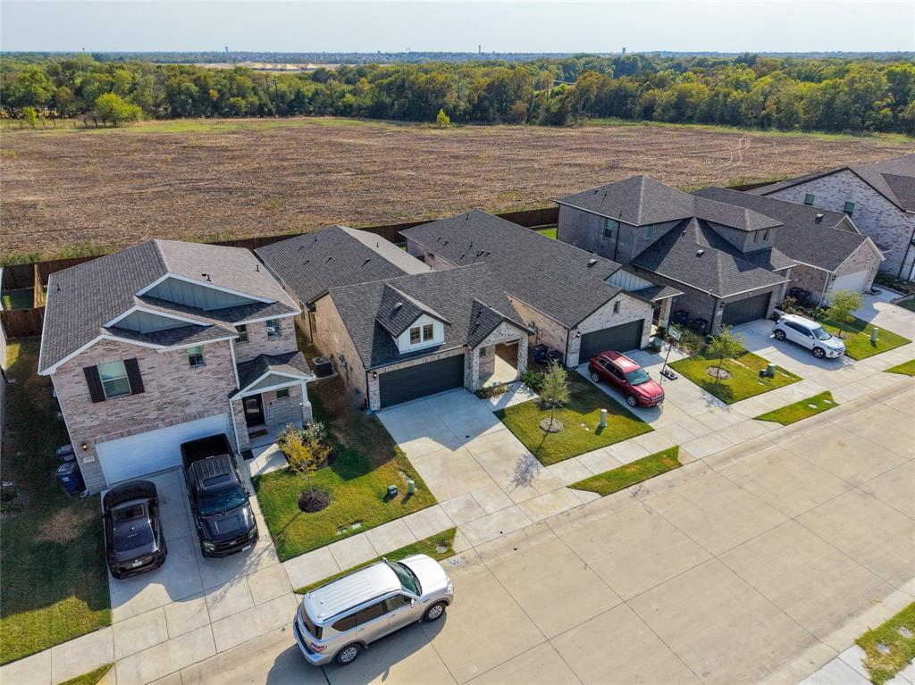 Brick exterior with dark shingle roofing