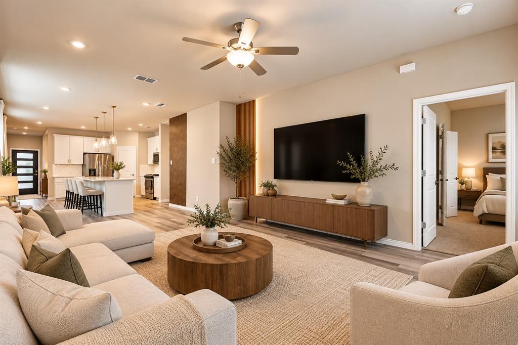Open-concept living space featuring wood-finish flooring, recessed lighting, and a ceiling fan