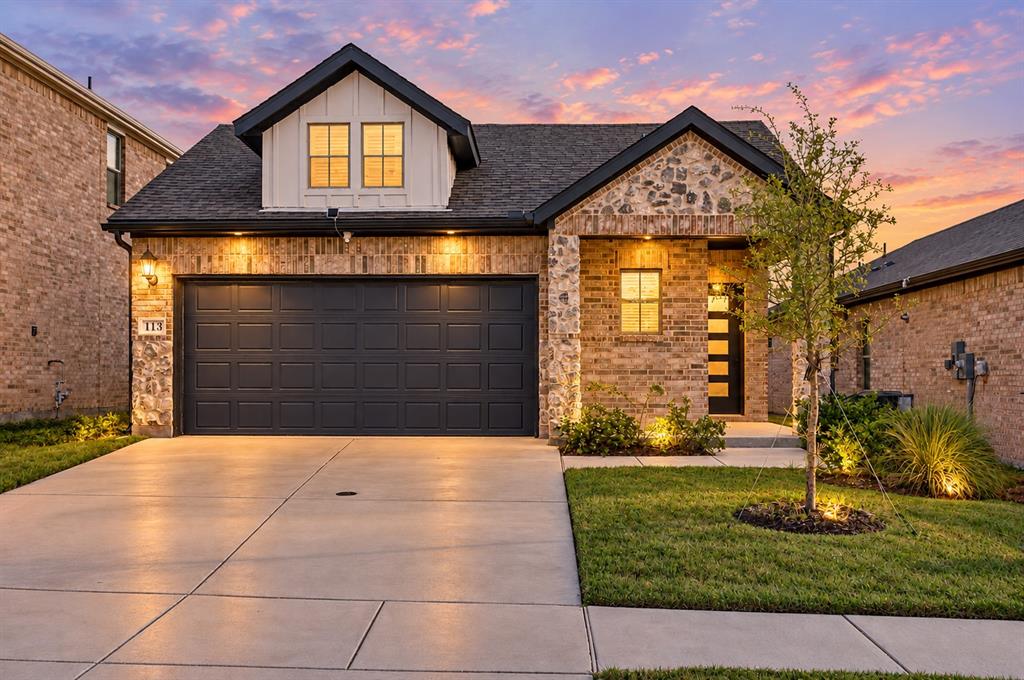 Brick and stone facade with a dark gray garage door