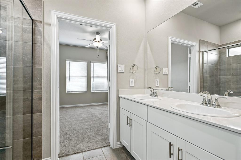 Dual vanity with undermount sinks, white cabinetry, and brushed nickel hardware