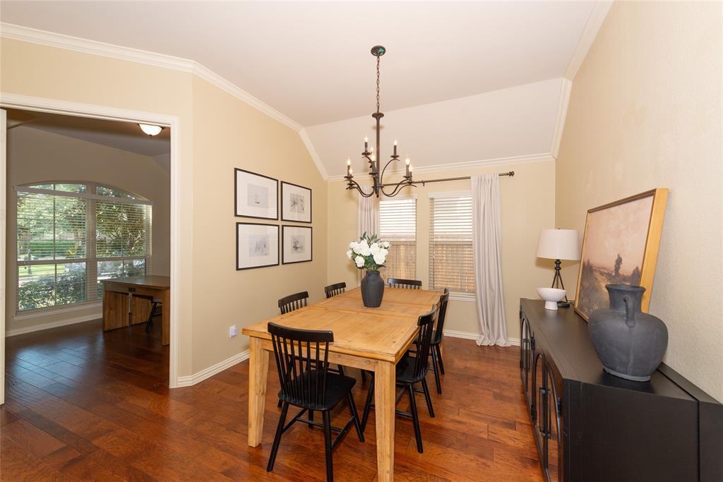 Wood-finish flooring throughout, vaulted ceiling, and crown molding Wood-finish flooring throughout, vaulted ceiling, and crown molding