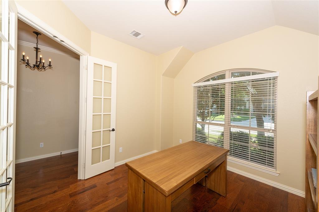 Wood-finish flooring throughout, French doors with glass panels, arched window, and recessed ceiling details Wood-finish flooring throughout, French doors with glass panels, arched window, and recessed ceiling details