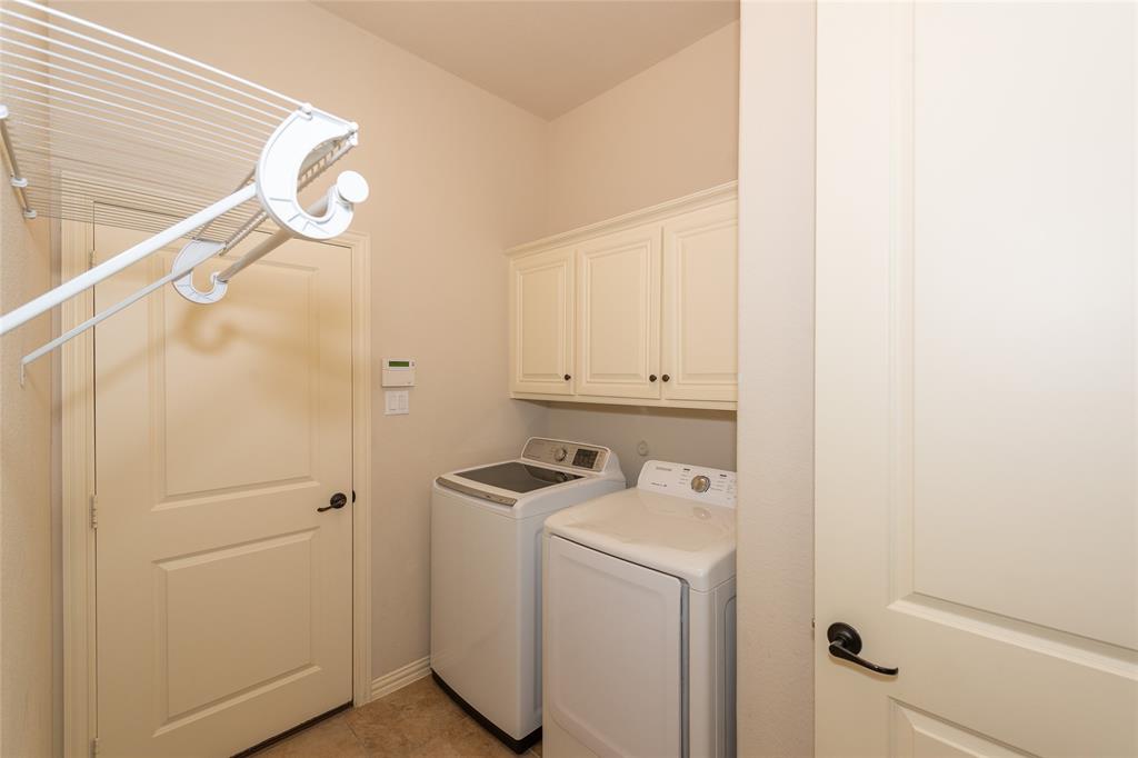 Built-in white cabinetry, light-toned walls, and a light-toned flooring
