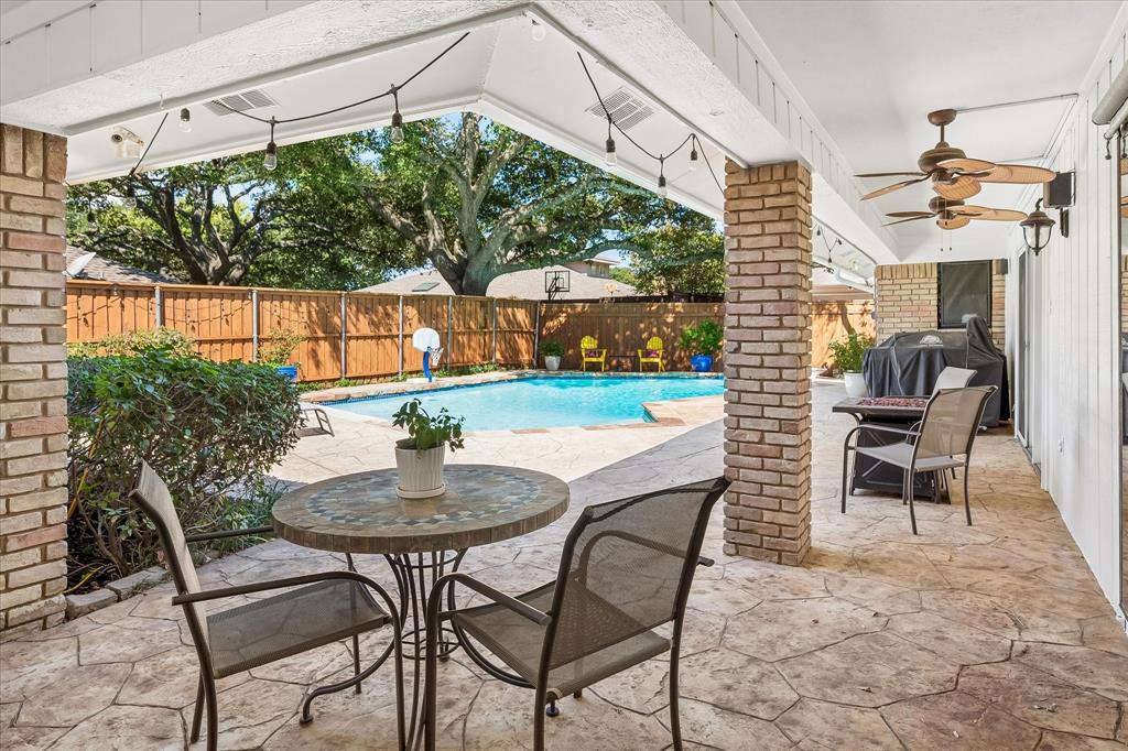 Covered patio with stamped concrete flooring and ceiling fans