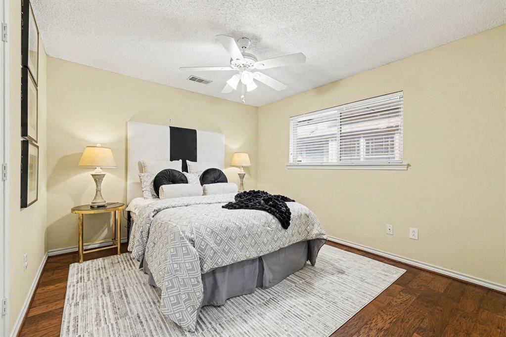 Wood-finish flooring, single window with blinds, ceiling fan, and light-toned walls