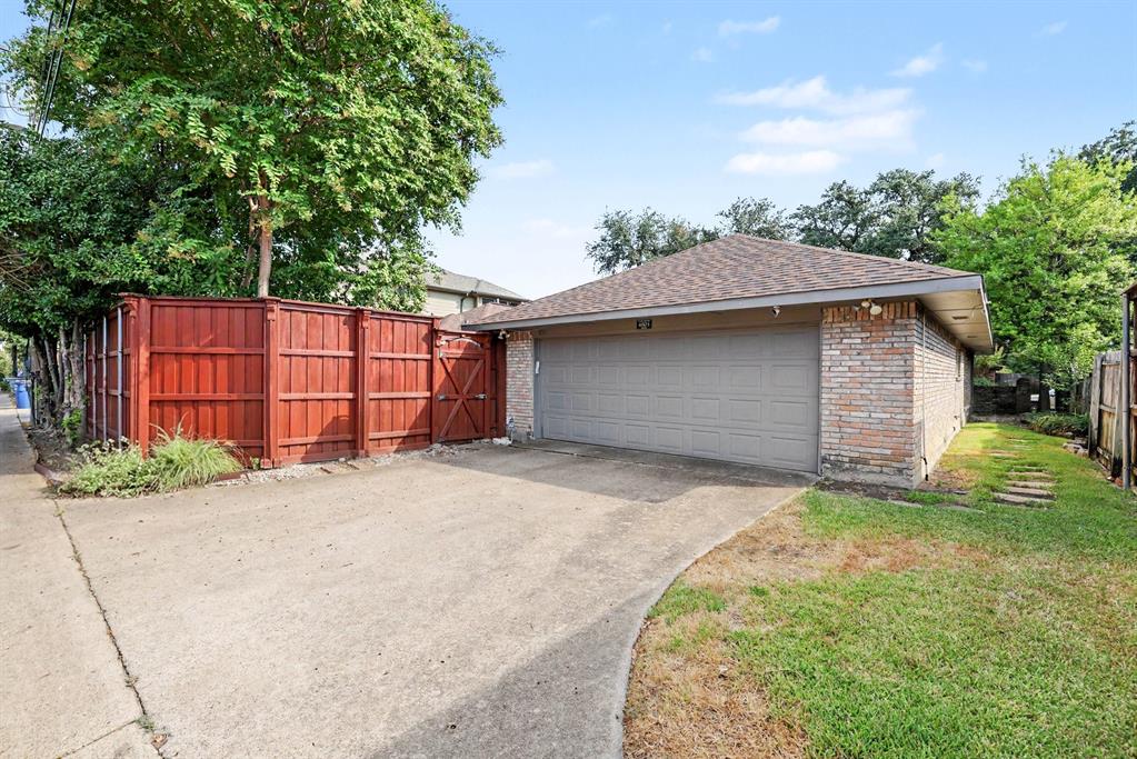 Attached two-car garage with brick veneer and composite shingle roof
