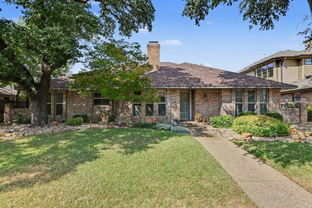 Brick exterior with a gabled roof and prominent chimney Brick exterior with a gabled roof and prominent chimney