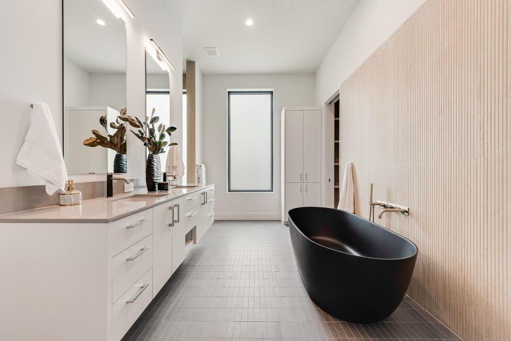 The spa-inspired bath features custom finishes and a calming, modern design.