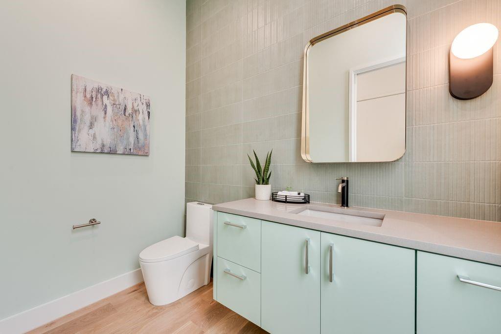 The powder bath is finished with elevated materials and a modern aesthetic.