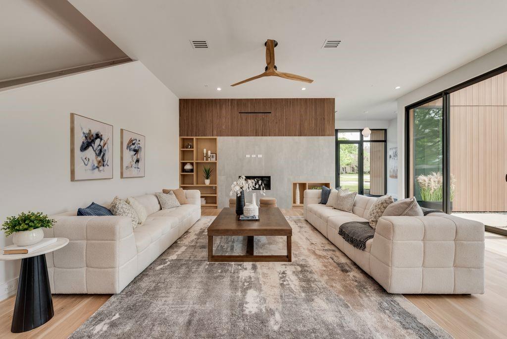 Custom built-ins and walnut mini fluted wood accents add depth, texture, and refined character.