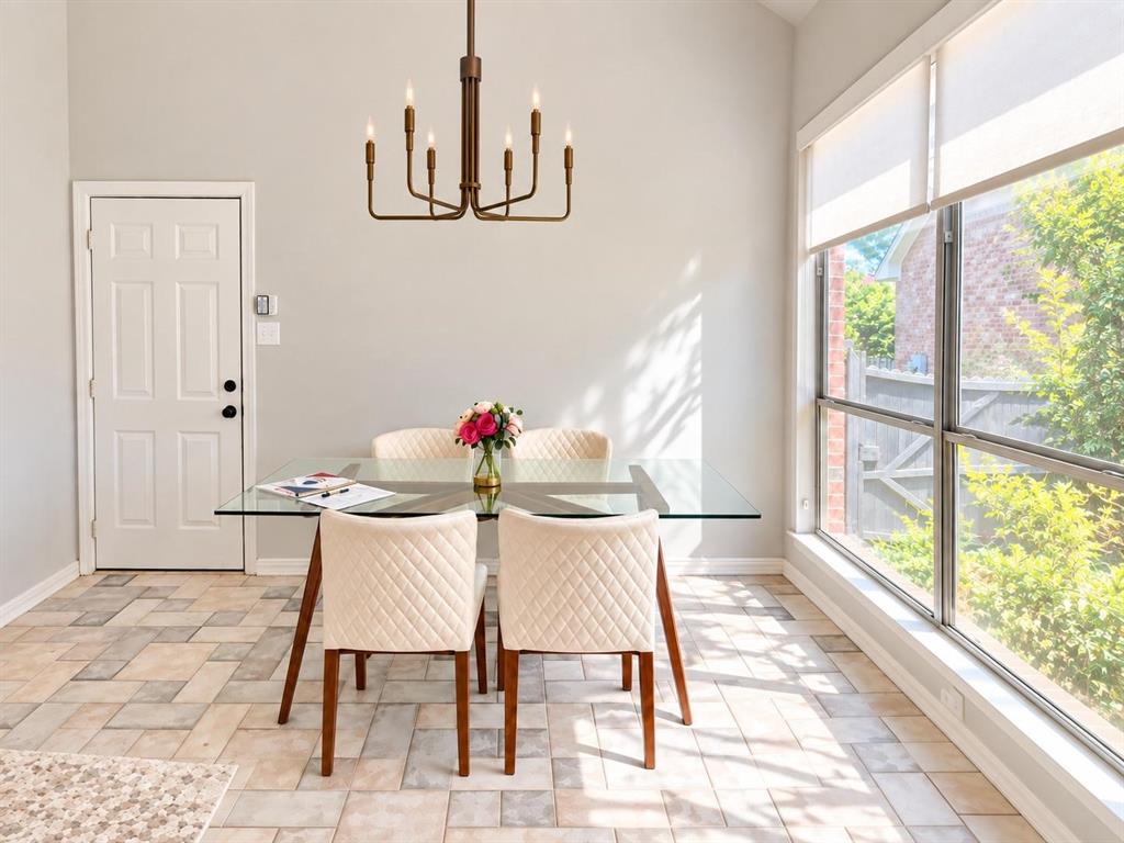 Recessed lighting, large picture windows with roller shades, a six-light chandelier, and patterned tile flooring