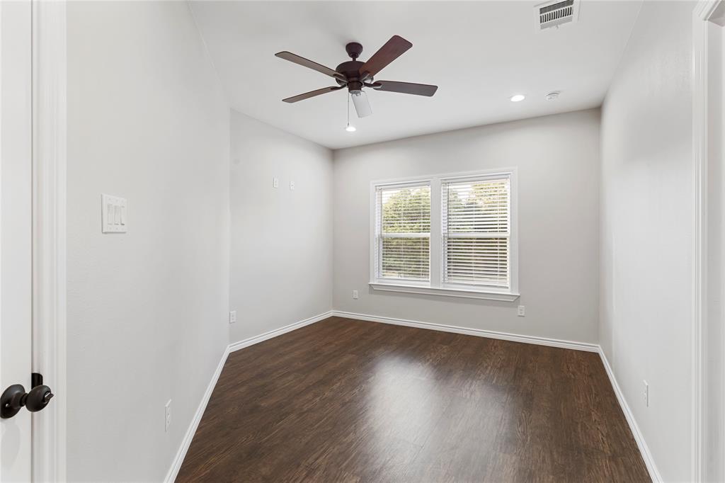 Wood-finish flooring with white trim, ceiling fan, recessed lighting, and a double window with blinds