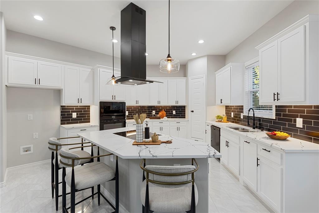 Kitchen featuring white shaker-style cabinetry, a large center island with a stone countertop, a built-in cooktop, and a matching black range hood