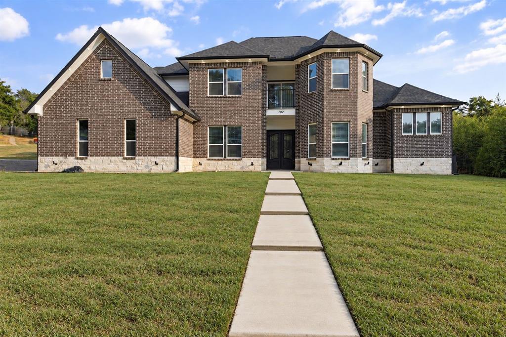 Brick exterior with stone accents and dark-framed windows