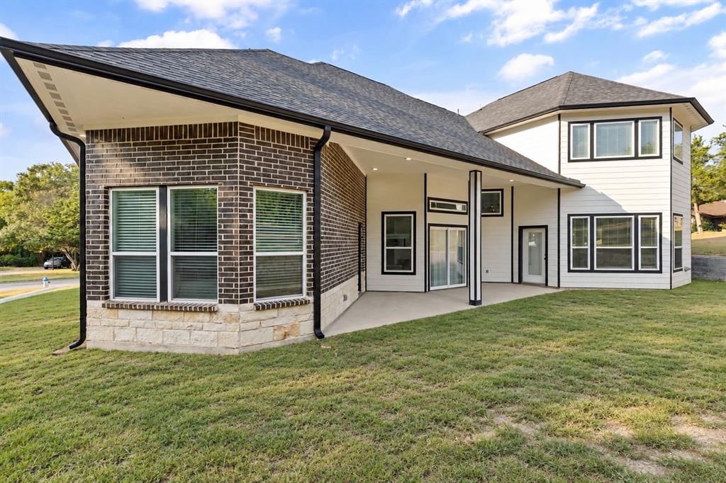 Exterior showcasing dark brick, stone veneer, and white siding